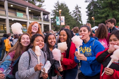group of students on the quad holding cotton candy